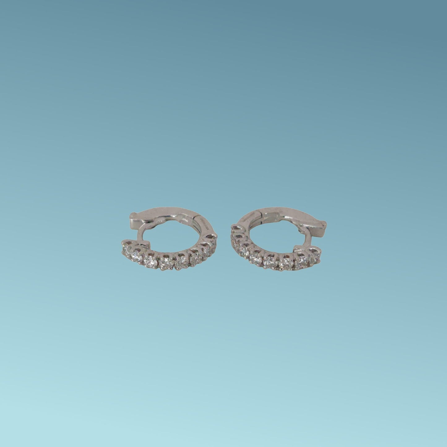 orecchini in oro bianco 18kt di mirco visconti a forma di cerchio 14mm con una fila di diamanti naturali taglio brillante incassati a griffes  di 0.14 ct