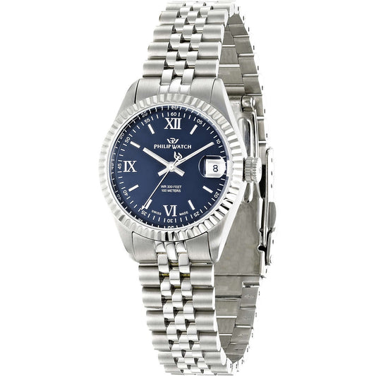 Orologio da donna con movimento al quarzo e funzioni di solo tempo con data. Cassa rotonda in acciaio inox dal diametro di 31 mm. Lunetta zigrinata in acciaio. Fondello e corona a vite. 
Quadrante blu con indici a bastoni e numeri romani, logo nella parte alta e datario a ore 3 con lente di ingrandimento. Vetro zaffiro.