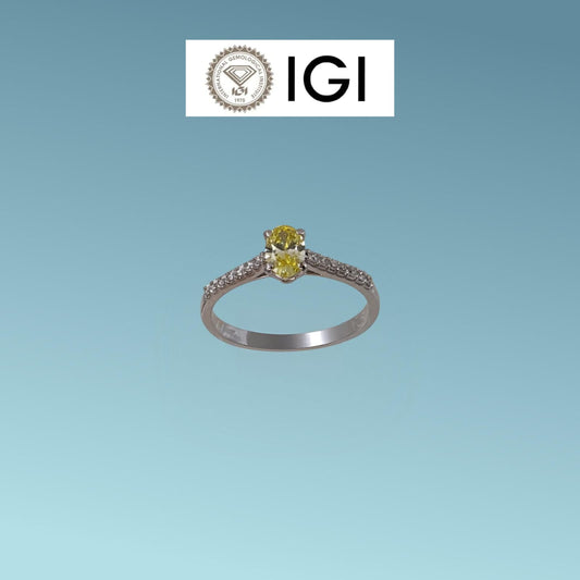 Anello in oro bianco 18kt di Meteore Gioielli con Diamante di Laboratorio Fancy Vivid Yellow ct 0.40 dal taglio ovale, sul gambo sono incassati ai due lati una fila di luminosissimi diamanti di laboratorio bianchi per un totale di 0.13 ct D/VS. 