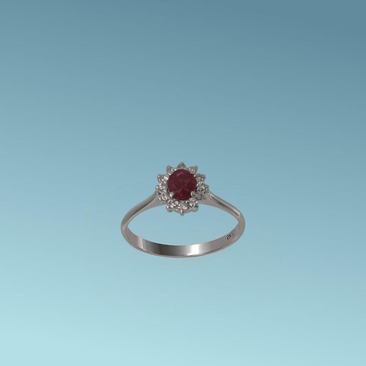 Anello con Rubino di Meteore Gioielli è realizzato Oro Bianco 18k,  presenta al centro un rubino naturale da 0.35 carati taglio ovale, incorniciato da una fila di diamanti naturali naturali taglio brillante ct 0.12.