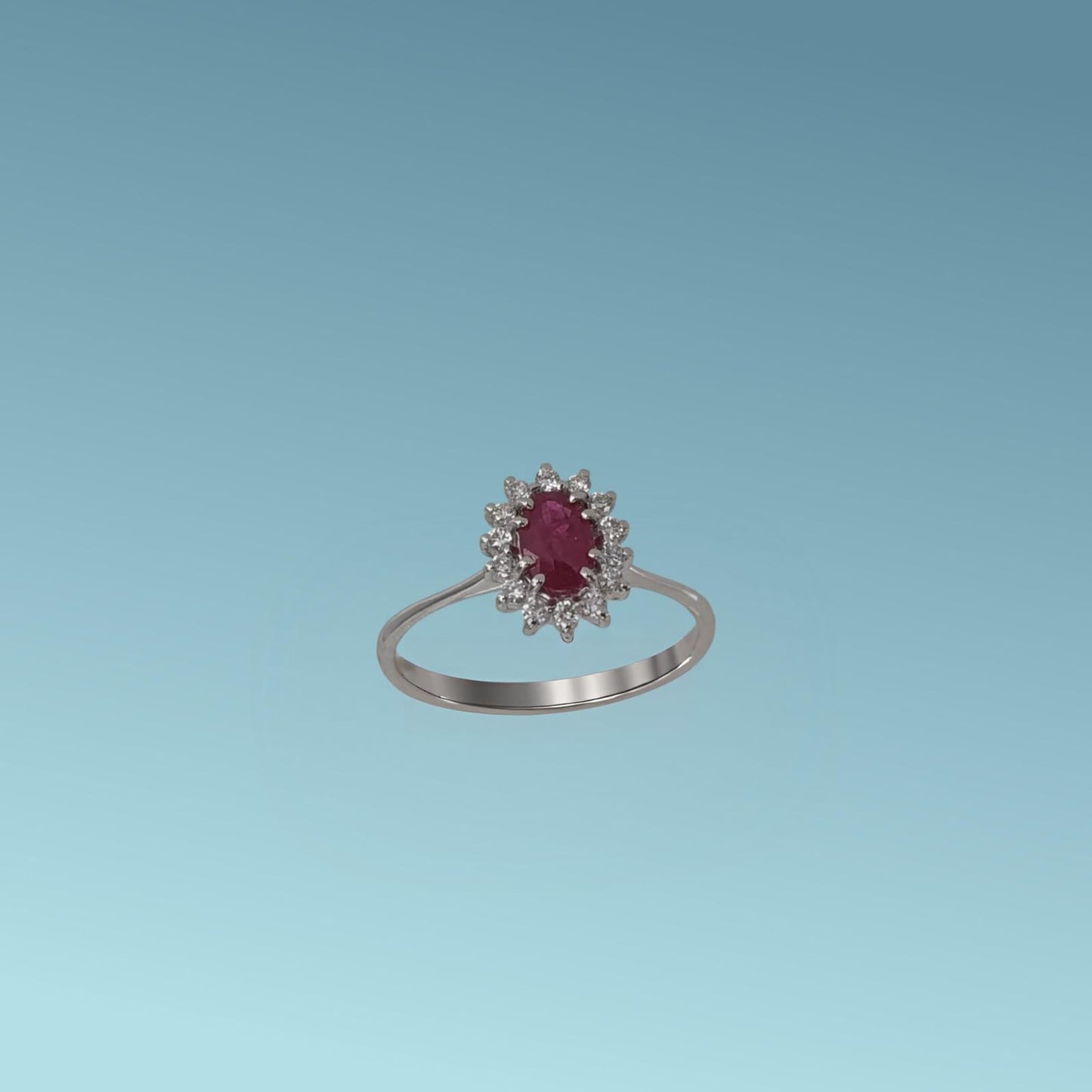 anello con rubino di meteore gioielli rappresenta una splendida armonia tra il colore intenso del rubino naturale taglio ovale ct 0.54 e la luminosità impeccabile dei diamanti naturali taglio brillante ct 0.15 g/vs.