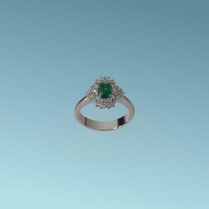 Anello in oro bianco 18kt di Meteore Gioielli è un capolavoro di maestria orafa, lo Smeraldo naturale ovale ct 0.45 posto al centro è esaltato dallo scintillio dei diamanti naturali taglio brillante ct 0.55