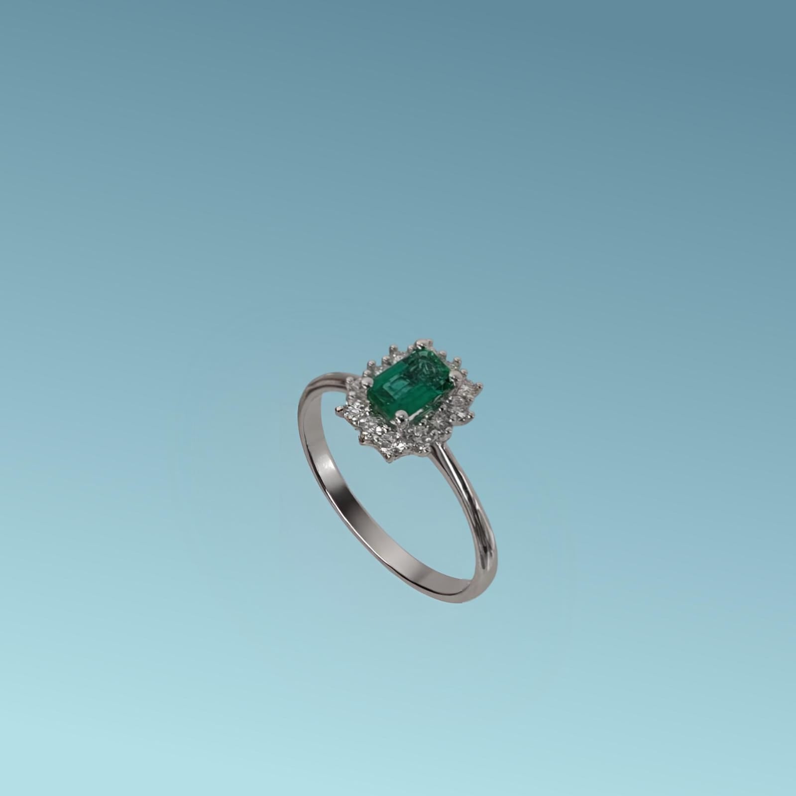 L'anello in oro bianco 18kt di Mirco Visconti presenta uno smeraldo centrale taglio rettangolare ct 0.46, e una fila di diamanti naturali ct 0.21 