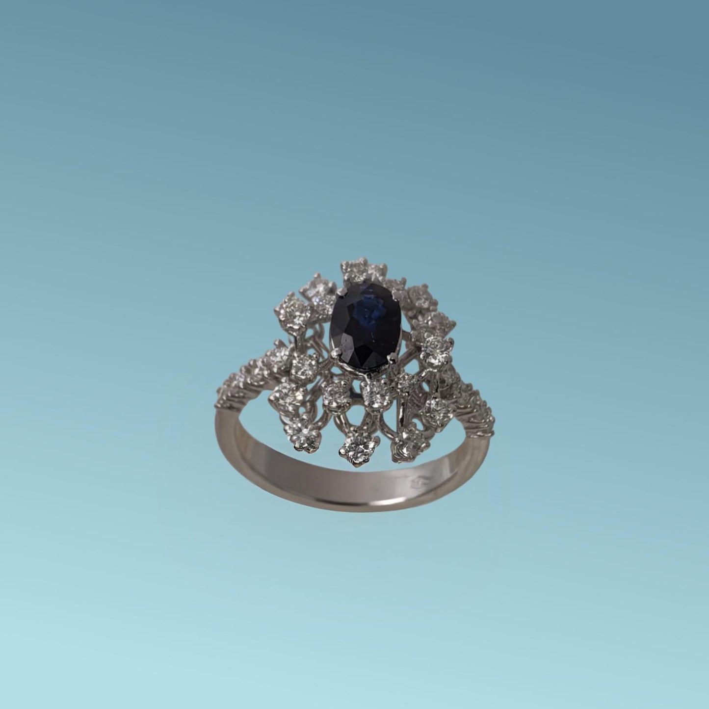 l' anello di meteore gioielli presenta una splendida armonia tra il blu intenso dello zaffiro naturale ct 0.91 posto al centro e la luminosità stellare dei diamanti naturali taglio brillante ct 0.72 g/vs. 