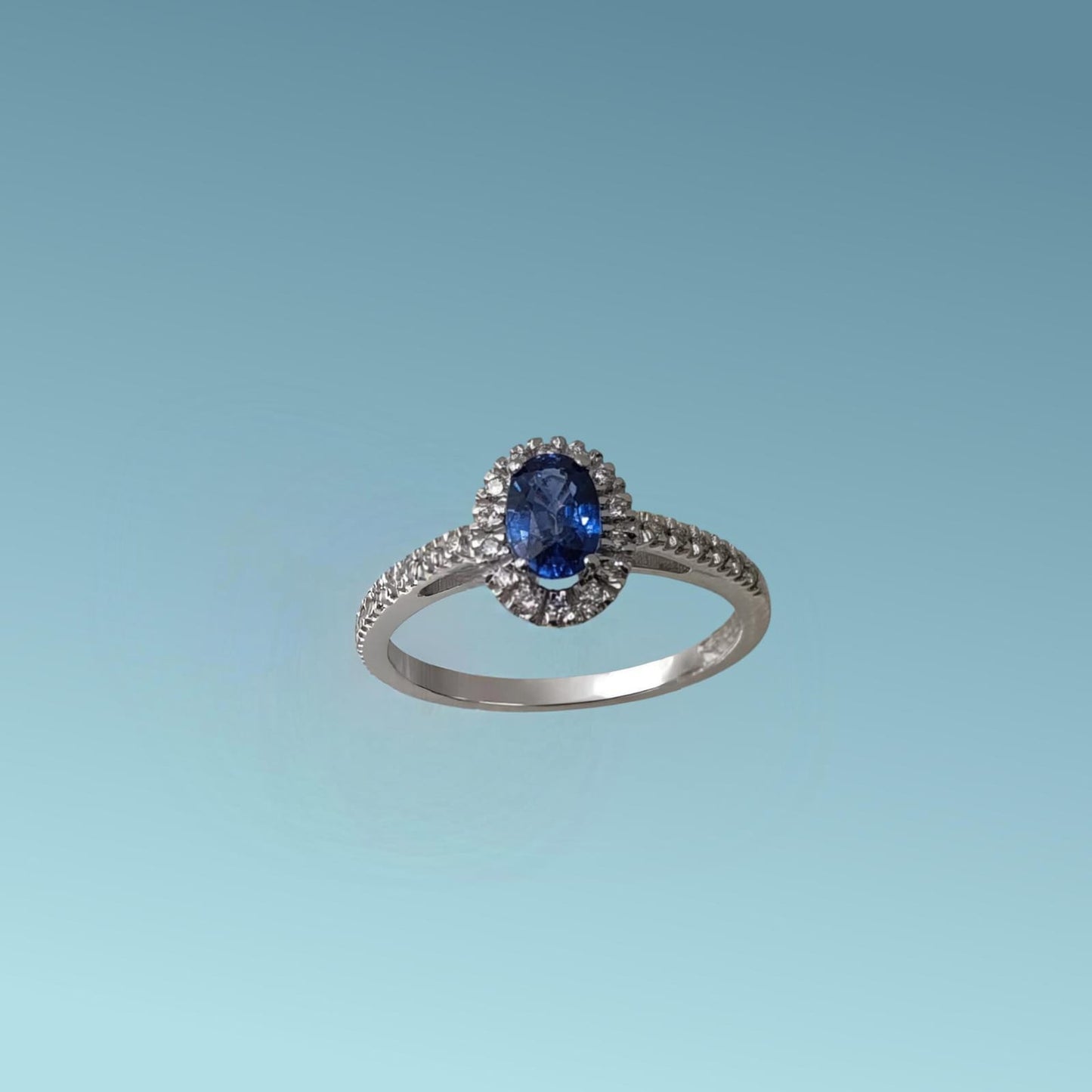 anello in oro bianco 18kt di meteore gioielli con zaffiro blu naturale taglio ovale ct 0.72 e una fila di diamanti naturali taglio brillante per un totale di 0.15 ct