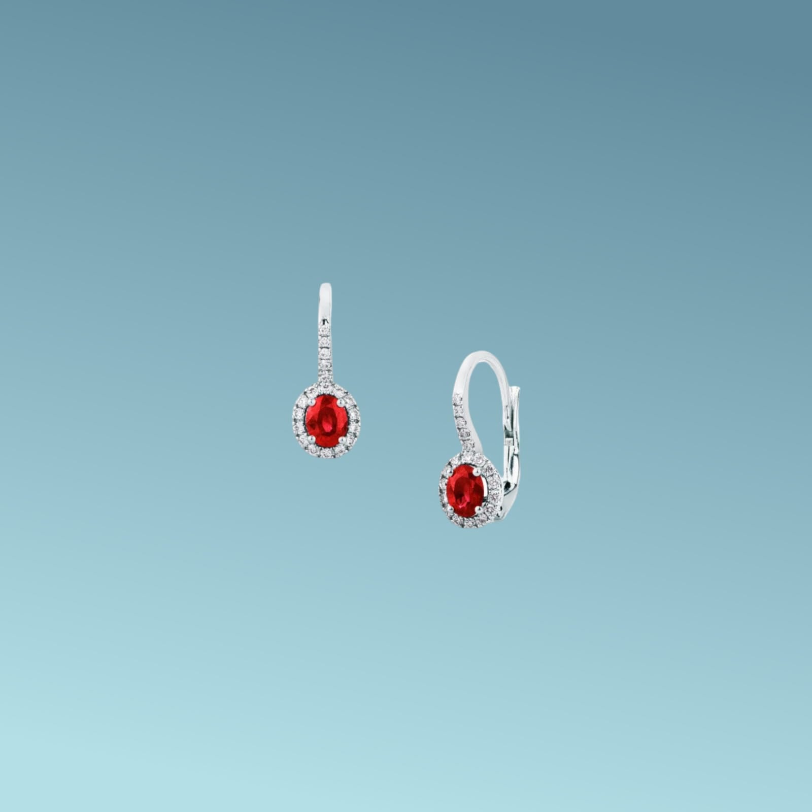 Orecchini in oro bianco 18kt di Mirco Visconti con chiusura a gancio pendente, presentano una coppia di rubini naturali taglio ovale per un totale di 0.87 ct contornati da diamanti naturali taglio brillante presenti anche sulla chiusura per un totale di 0.22 ct